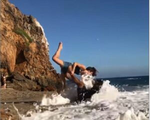 Coppia fa "beach yoga": arriva l'onda e...