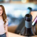 donna dice ok e bottiglia di vino vuota