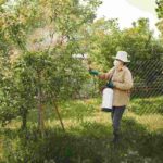 agricoltore spruzza pesticidi