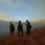 Pompieri al lavoro (foto Epa/Ansa)