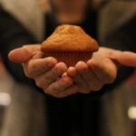 mani che tengono un muffin