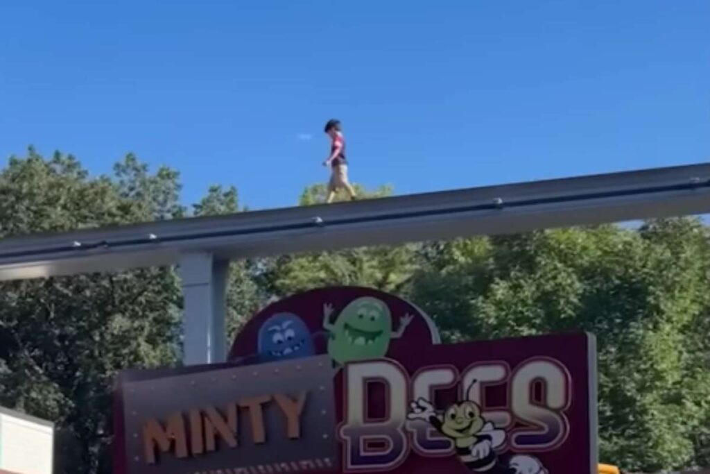 Bambino cammina sulla monorotaia di un parco divertimenti