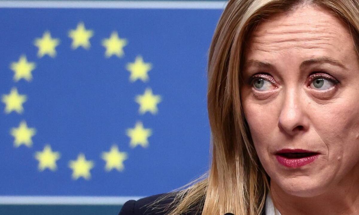 giorgia meloni con bandiera ue alle spalle