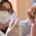 Una infermiera inietta un vaccino