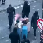 Parigi, il video delle turiste che trascinano il trolley in mezzo agli scontri e della coppia che sorseggia un drink vicino al cassonetto che brucia